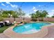 Private pool with a rock waterfall feature, lush landscaping and lounge area, perfect for outdoor enjoyment at 1365 N Drexel St, Mesa, AZ 85207