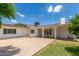 A view of the backyard shows a covered patio and desert landscaping at 1407 E 1St St, Mesa, AZ 85203