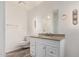 Renovated bathroom featuring a stylish vanity with granite countertop at 1407 E 1St St, Mesa, AZ 85203