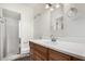 Bright bathroom with white countertop, wood cabinets, and walk-in shower at 1407 E 1St St, Mesa, AZ 85203