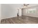 Bedroom with hardwood floors, a ceiling fan, and a large window at 1407 E 1St St, Mesa, AZ 85203