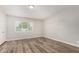 Bright bedroom featuring wood-look floors and natural light from window at 1407 E 1St St, Mesa, AZ 85203