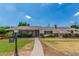 Charming single-story brick home with a well-manicured lawn and a welcoming pathway leading to the front door at 1407 E 1St St, Mesa, AZ 85203