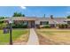 Charming single-story brick home with a well-manicured lawn and a welcoming pathway leading to the front door at 1407 E 1St St, Mesa, AZ 85203