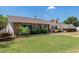 Charming single-story brick home with a well-manicured lawn and lush landscaping surrounding the property at 1407 E 1St St, Mesa, AZ 85203