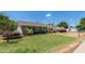 Charming single-story brick home with a well-manicured lawn and lush landscaping surrounding the property at 1407 E 1St St, Mesa, AZ 85203