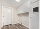 Laundry room with storage, updated floors, and access to back door at 1407 E 1St St, Mesa, AZ 85203