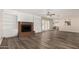 Bright living room with hardwood floors, a ceiling fan, and a red brick fireplace at 1407 E 1St St, Mesa, AZ 85203