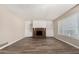 Spacious living room with a brick fireplace, built-in shelving, and modern flooring that creates a cozy and inviting atmosphere at 1407 E 1St St, Mesa, AZ 85203