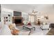 Staged living room featuring a brick fireplace, wood floors, sofa, and chairs at 1407 E 1St St, Mesa, AZ 85203