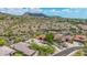 Expansive aerial view of desert community homes with red tile roofs, surrounded by natural desert landscape and distant mountains at 15953 N 111Th Way, Scottsdale, AZ 85255
