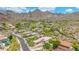 Scenic aerial view showcasing desert homes nestled near majestic mountains and green landscaping under a sunny, blue sky at 15953 N 111Th Way, Scottsdale, AZ 85255