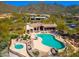 Aerial view of a community pool and hot tub overlooking the mountains at 15953 N 111Th Way, Scottsdale, AZ 85255