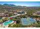 Stunning aerial view of community featuring pools, tennis courts, and beautiful desert landscaping at 15953 N 111Th Way, Scottsdale, AZ 85255