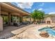 Expansive backyard featuring a covered patio, built-in grill, outdoor fireplace, and a refreshing pool at 15953 N 111Th Way, Scottsdale, AZ 85255