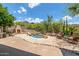 Lush backyard showcasing a tranquil pool and spa, along with a cozy outdoor fireplace at 15953 N 111Th Way, Scottsdale, AZ 85255