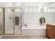 Bathroom with walk-in shower, soaking tub, and privacy windows at 15953 N 111Th Way, Scottsdale, AZ 85255