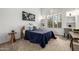 Guest bedroom with plantation shutters, wooden desk, and decorative furnishings at 15953 N 111Th Way, Scottsdale, AZ 85255