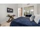 This bedroom features a sliding mirrored closet, a side table with decor, and a comfortable looking bed at 15953 N 111Th Way, Scottsdale, AZ 85255
