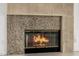 Close-up of the fireplace featuring a granite surround and a decorative, textured mantelpiece at 15953 N 111Th Way, Scottsdale, AZ 85255