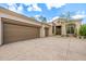 A wide driveway leads to a three-car garage and an arched entryway at 15953 N 111Th Way, Scottsdale, AZ 85255