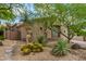 Desert home exterior surrounded by unique desert flora, showcasing low-maintenance landscaping and natural beauty at 15953 N 111Th Way, Scottsdale, AZ 85255