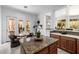 Stylish kitchen with granite countertops, wood cabinets, and a breakfast nook with views of the backyard at 15953 N 111Th Way, Scottsdale, AZ 85255