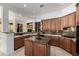 Spacious kitchen features granite counters, custom cabinets, and a functional center island at 15953 N 111Th Way, Scottsdale, AZ 85255