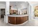 Kitchen with bar seating features wood cabinetry, granite countertops, and an open layout at 15953 N 111Th Way, Scottsdale, AZ 85255