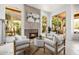 Inviting living room with a modern fireplace, comfortable seating, and large windows with garden views at 15953 N 111Th Way, Scottsdale, AZ 85255