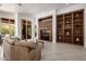 Expansive living room with built-in shelving and seamless indoor-outdoor living at 15953 N 111Th Way, Scottsdale, AZ 85255