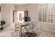 Bright office featuring a desk, comfortable chairs, and plantation shutters at 15953 N 111Th Way, Scottsdale, AZ 85255