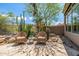 Inviting outdoor patio with comfortable wicker seating and desert landscaping, creating a serene relaxation space at 15953 N 111Th Way, Scottsdale, AZ 85255
