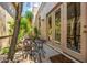 Patio featuring outdoor seating surrounded by plants and stone, and a view into the home's interior at 15953 N 111Th Way, Scottsdale, AZ 85255