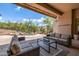 Cozy outdoor patio with comfortable seating, a desert landscape, and a partially covered patio at 15953 N 111Th Way, Scottsdale, AZ 85255