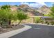 Street-level view captures a desert home with tasteful landscaping, complemented by a scenic mountain backdrop, blending nature and home at 15953 N 111Th Way, Scottsdale, AZ 85255