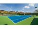Well-maintained tennis courts with vibrant blue and green surfaces, set against a backdrop of scenic hills at 15953 N 111Th Way, Scottsdale, AZ 85255