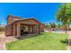 Expansive backyard features a covered patio, well-manicured lawn, and a refreshing swimming pool at 16284 W Desert Mirage Dr, Surprise, AZ 85379