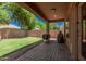 Covered backyard patio with brick pavers, offering a relaxing outdoor living space at 16284 W Desert Mirage Dr, Surprise, AZ 85379
