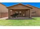 Inviting backyard patio with a covered area, perfect for outdoor dining and entertaining at 16284 W Desert Mirage Dr, Surprise, AZ 85379