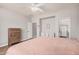 Bright primary bedroom with wood floors, ceiling fan and ensuite bathroom at 16284 W Desert Mirage Dr, Surprise, AZ 85379