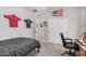 A cozy bedroom featuring patriotic decor, a work space, and a comfortable bed at 16284 W Desert Mirage Dr, Surprise, AZ 85379