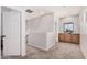 A well-lit upstairs hallway with plush carpeting and a built-in cabinet at 16284 W Desert Mirage Dr, Surprise, AZ 85379