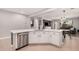 Bright eat-in kitchen featuring a large island with seating, stainless appliances, and white cabinetry at 16284 W Desert Mirage Dr, Surprise, AZ 85379
