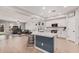 Bright eat-in kitchen featuring a large island with seating, stainless appliances, and white cabinetry at 16284 W Desert Mirage Dr, Surprise, AZ 85379
