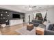 Comfortable living room featuring shiplap accent wall, floating shelves and backyard access at 16284 W Desert Mirage Dr, Surprise, AZ 85379