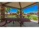 Covered picnic area with stone columns, metal tables, and a grill in a community park at 16284 W Desert Mirage Dr, Surprise, AZ 85379