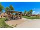 Community picnic pavilions with stone columns, metal tables, and grilling stations in a landscaped park at 16284 W Desert Mirage Dr, Surprise, AZ 85379