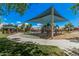 Playground with swings, slide, and shade structure, plus picnic pavilion in a community park at 16284 W Desert Mirage Dr, Surprise, AZ 85379
