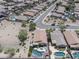 An aerial view showing many houses with pools and landscaping, in a well-planned community at 16404 S 18Th Dr, Phoenix, AZ 85045